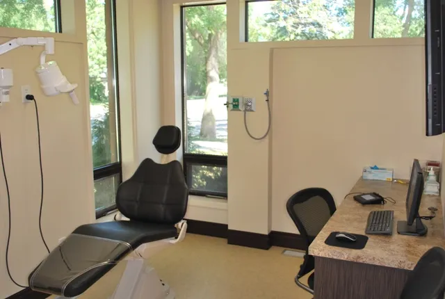 Close-up of a modern dental treatment chair and adjustable medical overhead lighting.