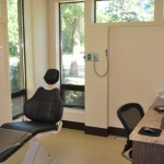 Close-up of a modern dental treatment chair and adjustable medical overhead lighting.