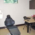 Close-up of a modern dental treatment chair and adjustable medical overhead lighting.