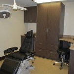 Clinical treatment room featuring a reclining dental chair and integrated medical equipment.