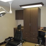 Clinical treatment room featuring a reclining dental chair and integrated medical equipment.